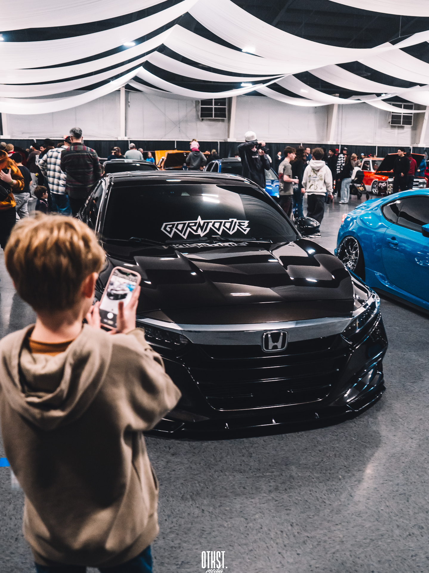 Pacific Auto Fest attendees gathered around modified cars in misty PNW weather